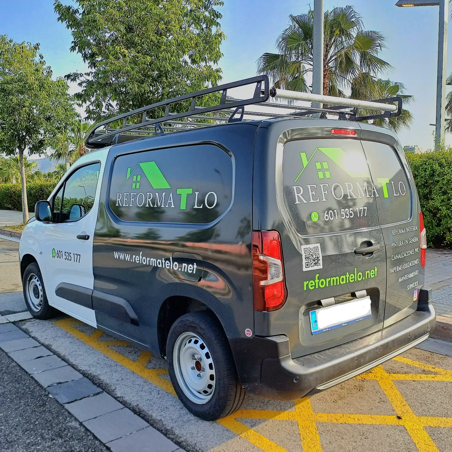 Furgoneta rotulada de Reformatelo con el teléfono y la web en los laterales